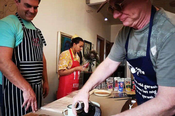 Immerse yourself in a delightful biltong-making experience where laughter and learning blend over hearty meals and traditional songs celebrating South African culture in a welcoming setting.